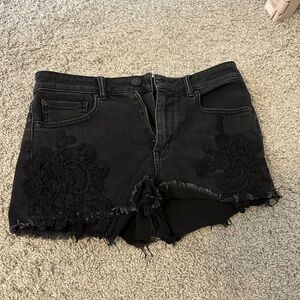 Black jean shorts with lace trim. Size 8